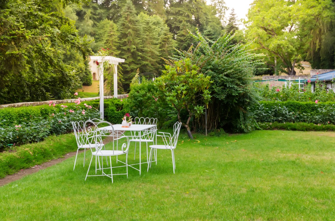 Coffee table in yard, ancient European tourist city. Summer tourism and travels, famous europe landmark